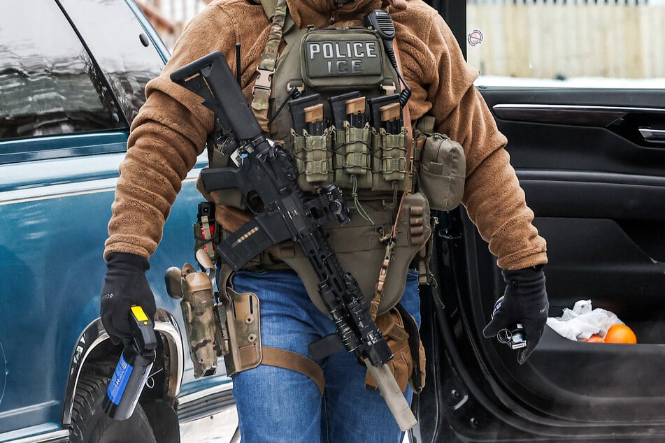 A masked federal immigration agent wearing a "Police ICE" badge is pictured in Minneapolis, Minnesota, on February 4, 2026.
