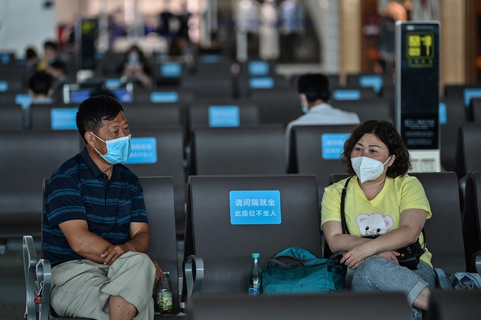 Passengers at an airport in Wuhan, China, the city where the coronavirus and the Covid-19 pandemic is said to have originated.