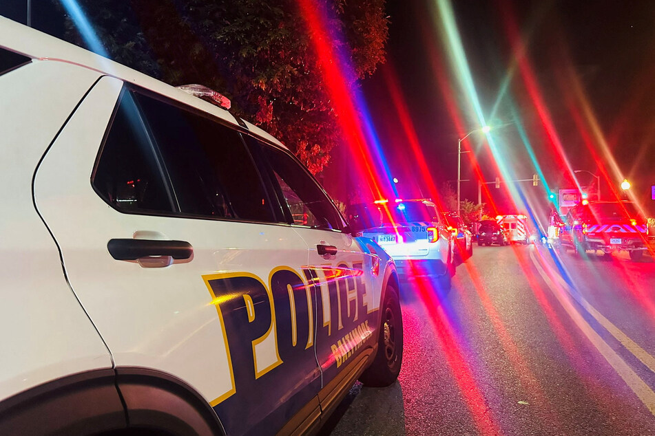 Police vehicles are seen following a shooting incident that happened at Morgan State University in Baltimore, Maryland, on October 3, 2023.