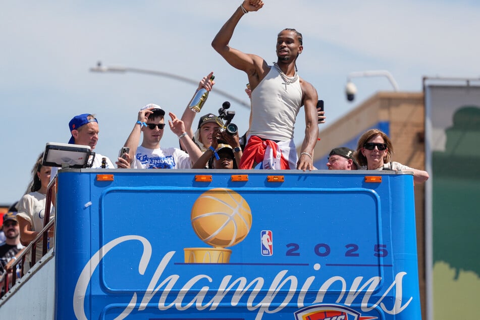 Oklahoma City Thunder players slapped hands with fans and let supporters touch the NBA championship trophy during a parade on Tuesday to celebrate the team's first title.