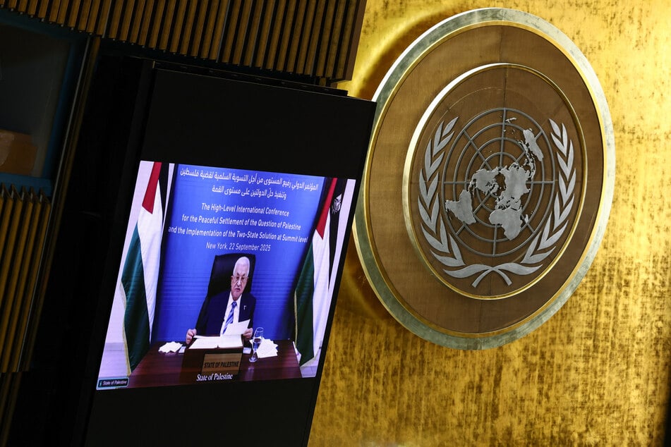 Palestinian Authority President Mahmoud Abbas is displayed on a screen as he speaks remotely during the United Nations General Assembly in New York on September 22, 2025.