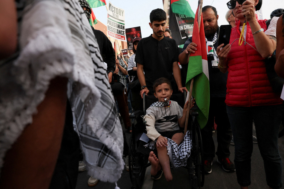 Baraa Hadi Abu Alroos, a 7-year-old who was injured in Rafah and lost his father and grandfather, attends a Gaza solidarity protest on the sidelines of the Democratic National Convention in Chicago, Illinois.