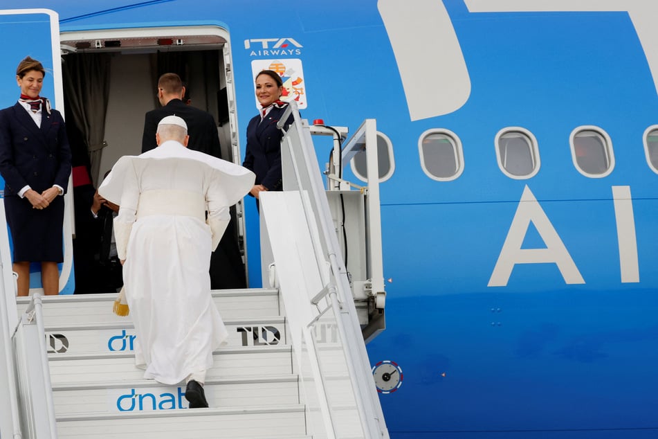 Pope Leo XIV boards the papal plane at Fiumicino Airport on April 13, 2026.