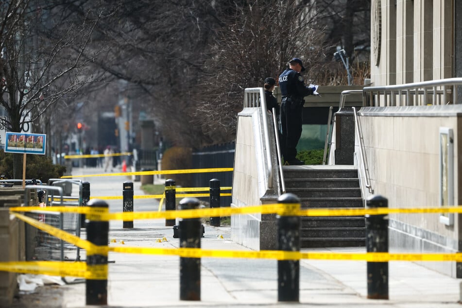 Police officers work around the scene of a shooting at the US Consulate in Toronto, Canada, on March 10, 2026.