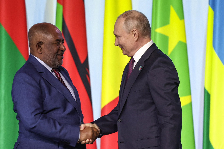 Russian President Vladimir Putin and Comoros President Azali Assoumani, the chair of the African Union, shake hands during a join briefing for media at a the final day of the Russia-Africa summit in St. Petersburg.