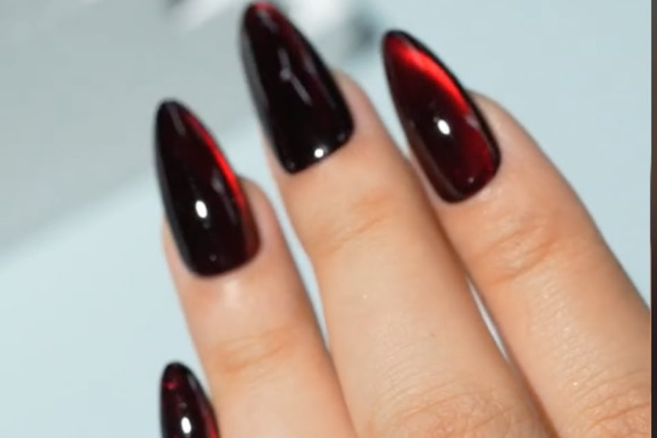 TikToker @sailornailsart saved spooky season with these red wine glass nails.