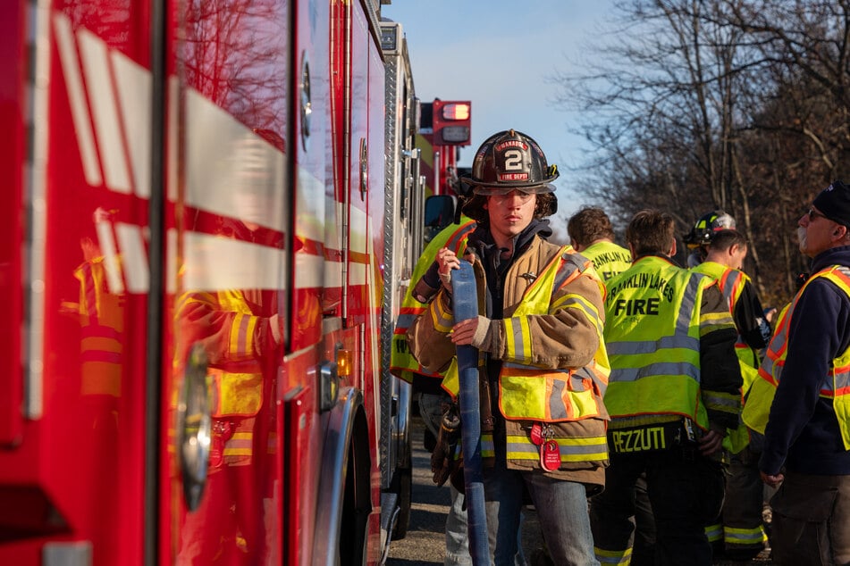 Firefighters work on battling a series of brush fires on Saturday outside of Pompton Lakes, New Jersey.