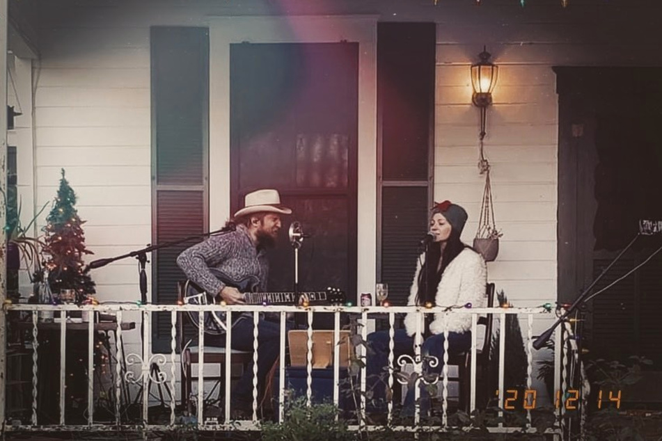 Nick and Paige DeChausse perform as The Reverent Few on their front porch.