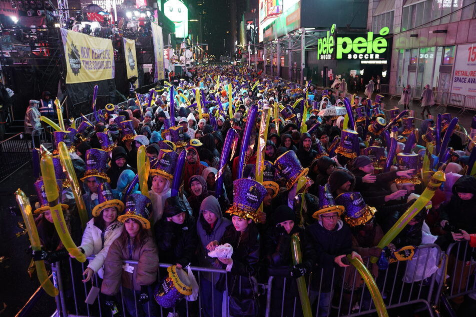 Revelers in Times Square wait for the midnight ball drop during the New Year's Eve celebration on December 31, 2022 in New York City.