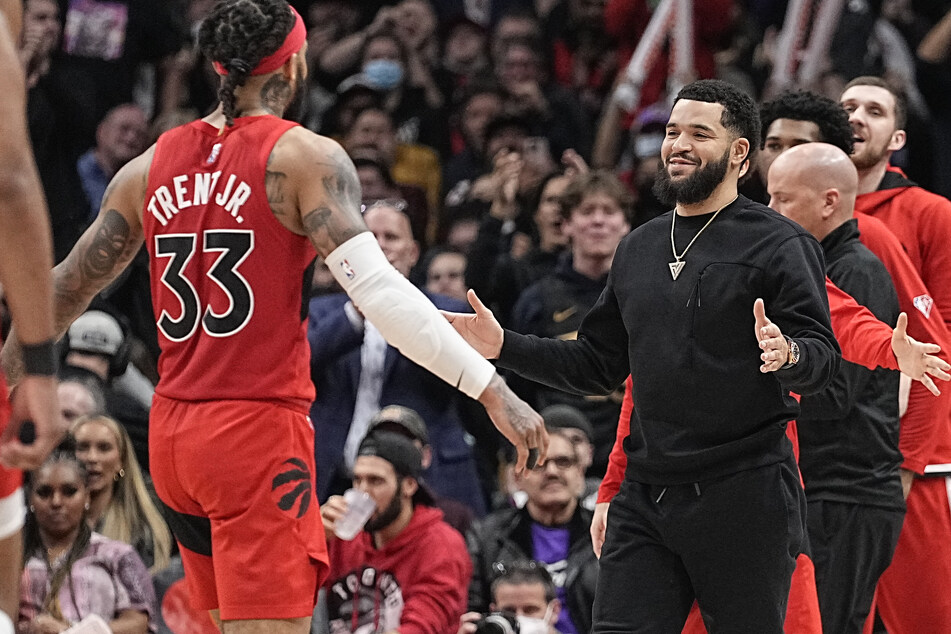 Toronto Raptors guard Fred VanVleet (r.) goes to hug Gary Trent Jr. after the Raptors' win over the Sixers.