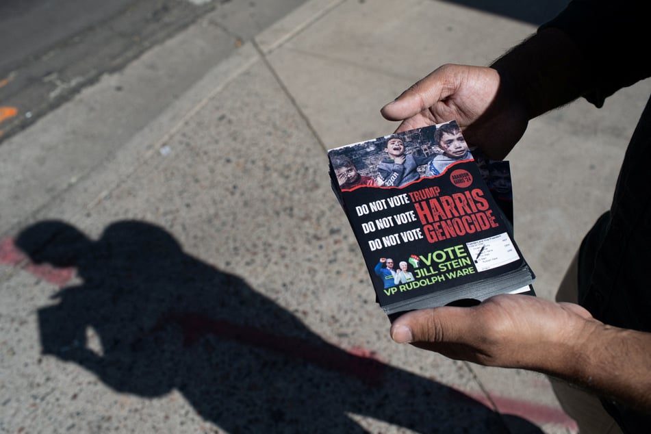 A volunteer holds flyers as he canvasses for the Abandon Harris campaign, encouraging people to vote for the Green Party, in Tempe, Arizona.