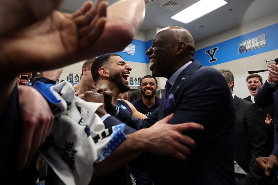 Yale Head Coach James Jones (r.) and Guard Yassine Gharram celebrate after taking down No. 4 Auburn in a shocking March Madness first round win.