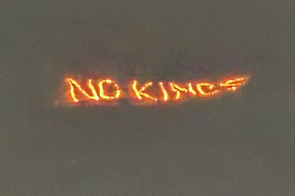A lit-up sign put up over Davos, Switzerland, reads "No Kings" on January 20, 2026, ahead of President Donald Trump’s visit to the 56th annual World Economic Forum meeting.