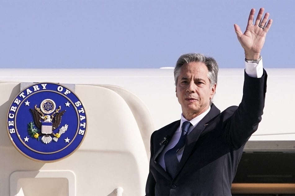 US Secretary of State Antony Blinken waves before boarding his aircraft at Ben Gurion International Airport in Lod on October 23, 2024, as he departs for Riyadh for the Saudi leg of his trip.