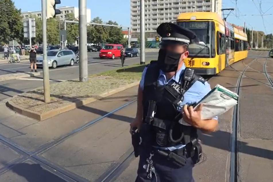 After the announcement, the officer took a few steps back and put his hand on his service weapon.