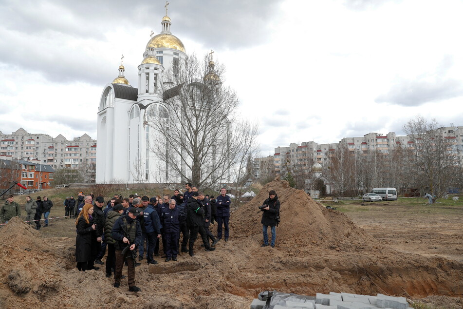French forensics investigators look into the mass grave discovered in the town of Bucha, near Kyiv.