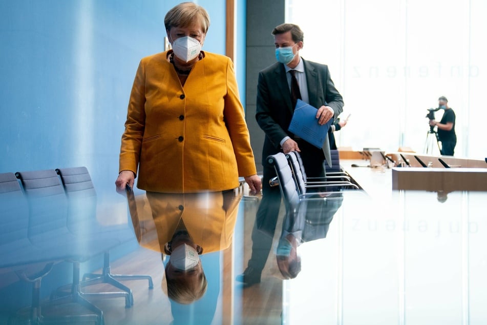 Chancellor Angela Merkel with government spokesman Steffen Seibert.