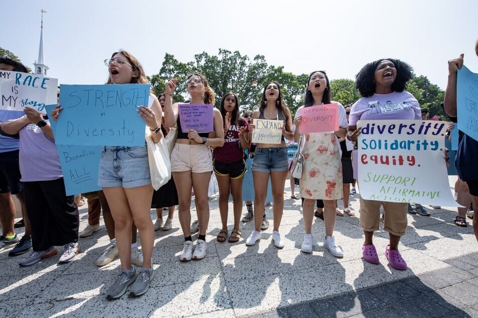Proponents of affirmative action hold signs during a protest at Harvard University in Cambridge, Massachusetts.