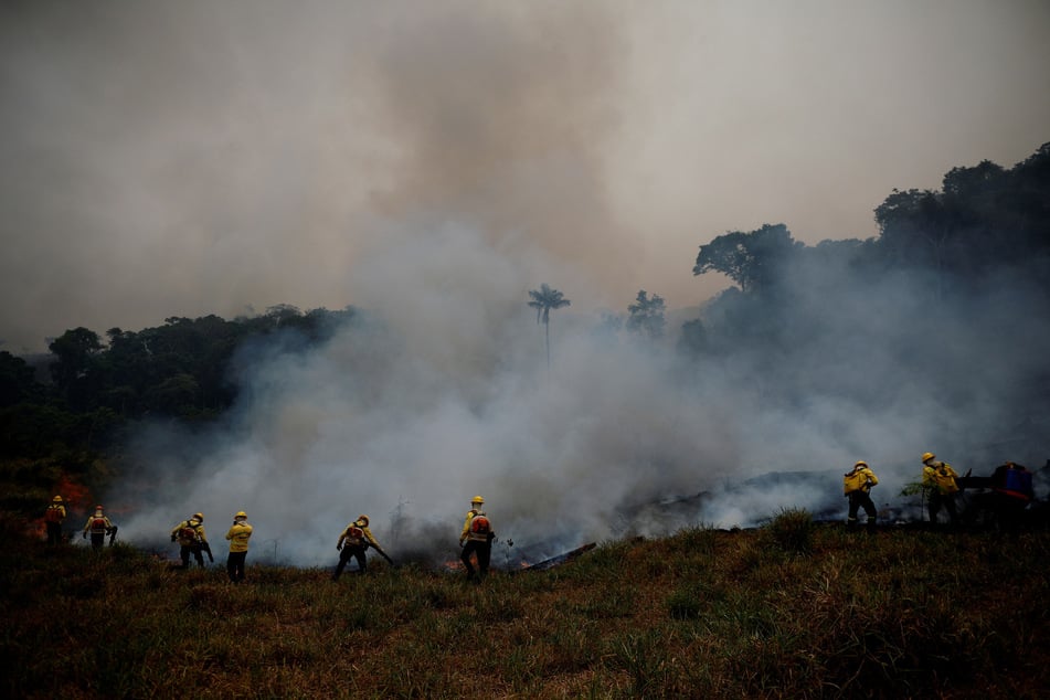 Members of the Brazilian Institute for the Environment and Renewable Natural Resources fire brigade work to extinguish a fire rising in the Amazon rainforest in Apui, Brazil, on August 8, 2024.