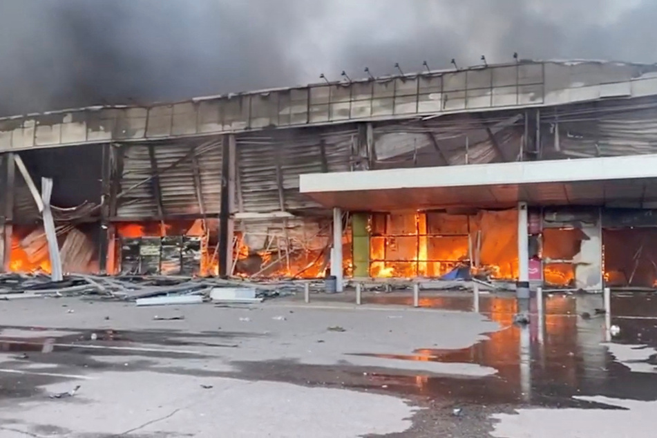 The shopping mall in Kremenchuk burning after a Russian missile attack.