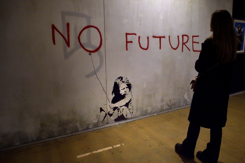 A visitor taking in the work of Banksy during the art exhibition The World of Banksy in Rome. London will host the largest collection of his works to date in July.