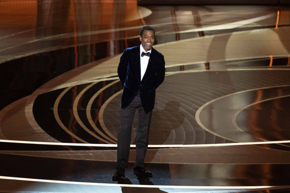 During a stand-up routine in Boston, Chris Rock briefly addressed Will Smith's Oscar slap.