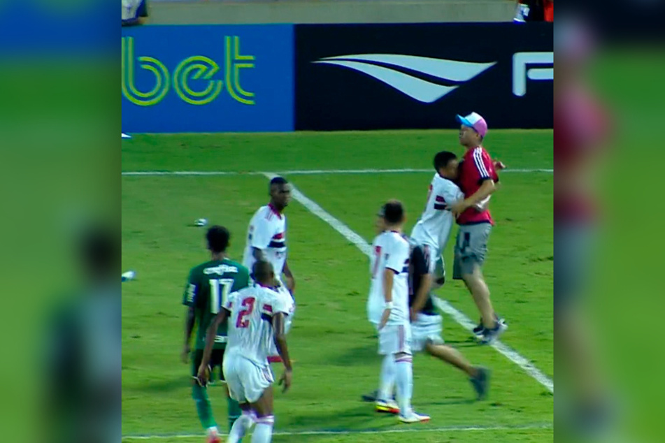 FC-Sao-Paulo-Stürmer Caio Matheus (17, 2.v.r.) hielt den Platzstürmer zurück.