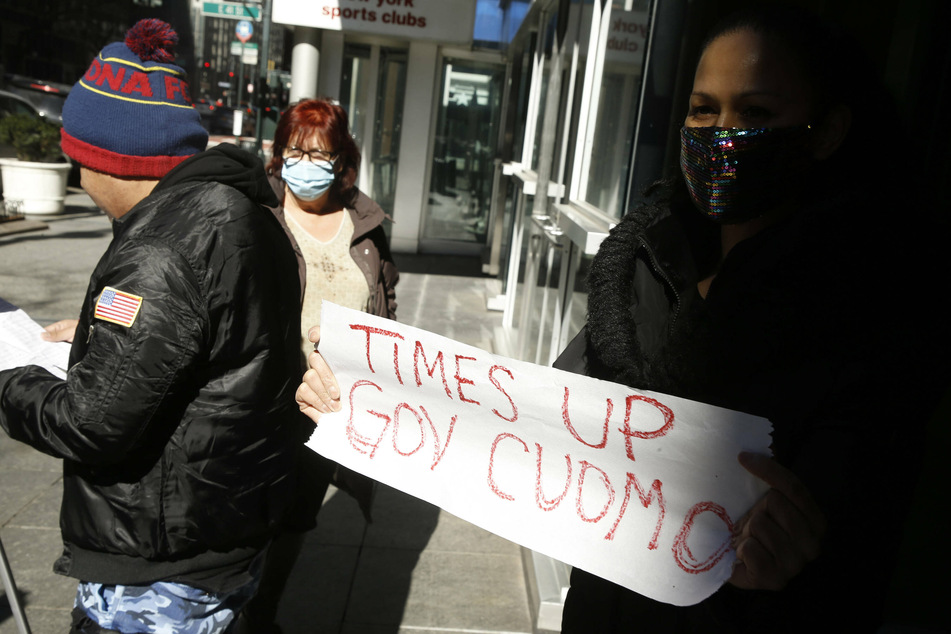 City council candidate Marni Halasa holds a "Time's Up" sign in front of Governor Andrew Cuomo's Third Avenue office in New York City.