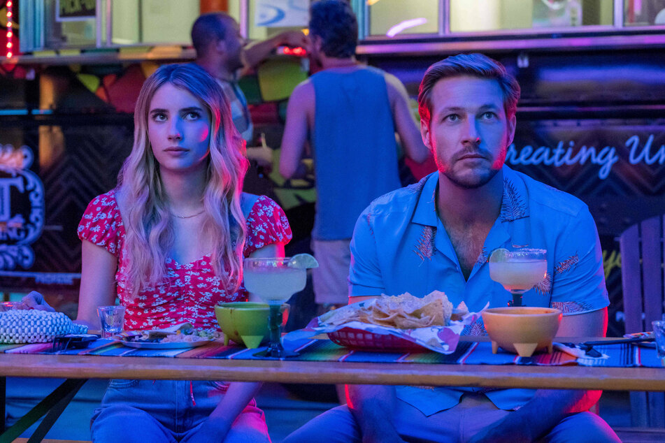 Emma Roberts (left) and Luke Bracey (right) play two strangers who try love in Holidate.