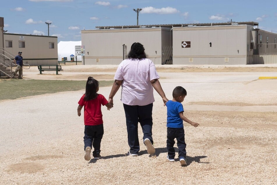 A detained woman and two children walk through the South Texas Family Residential Center outside Dilley, Texas, in 2019.