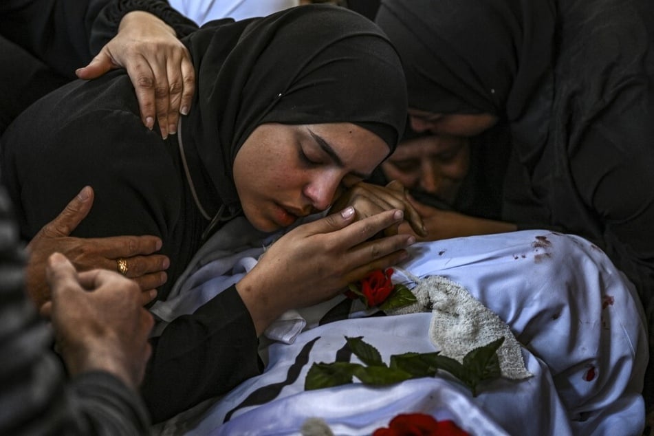 A woman mourns over the body of a man killed in an Israeli raid in the Nur Shams camp for Palestinian refugees in the occupied West Bank.