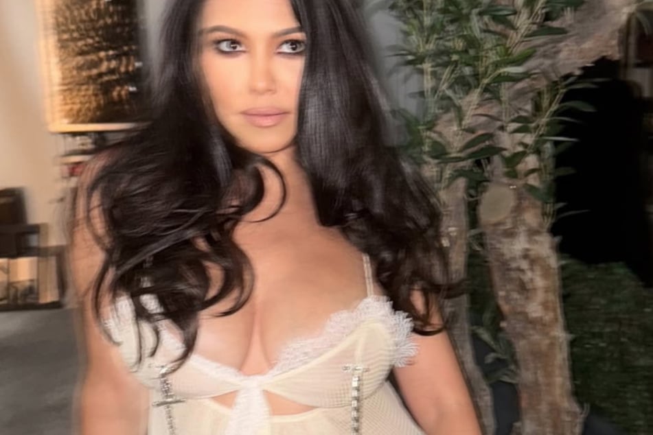 Kourtney Kardashian bared her bosom in a sexy lingerie top that also featured tiny nipple clamps.