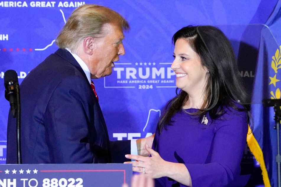 Donald Trump bringing Representative Elise Stefanik (r.) to the stage during a campaign event in Concord, New Hampshire, last month.