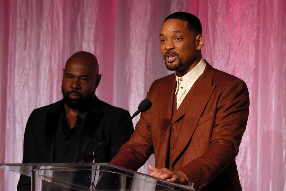 Will Smith (r) and director Antoine Fuqua accepted the Beacon Award at the African American Film Critics Association Awards.