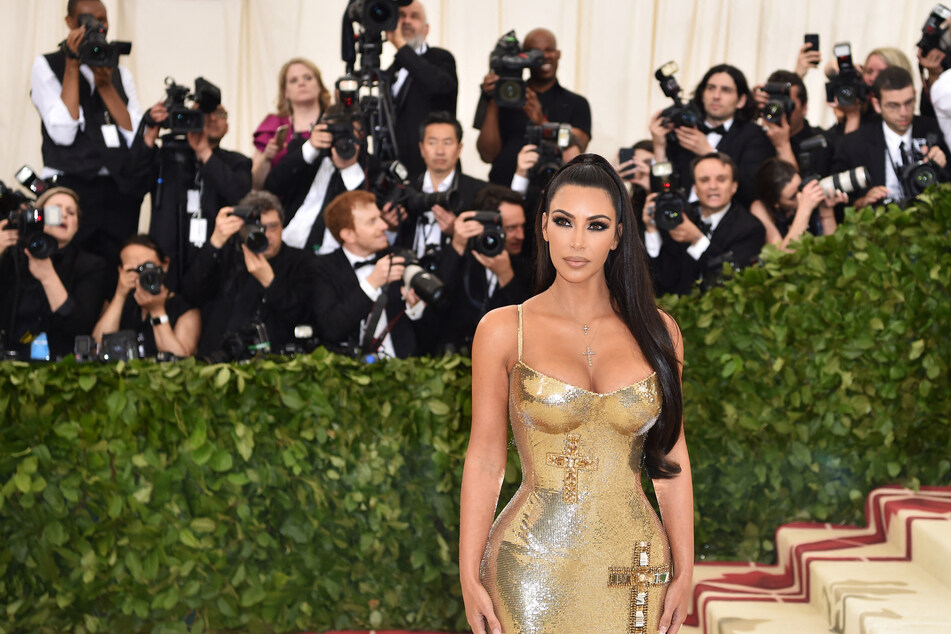 In 2018, Kim Kardashian turned heads when she sported a chic Versace body-con gown that featured crucifix imagery.