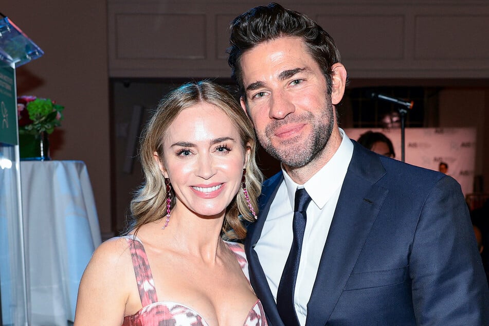 John Krasinski (r.) joked that his wife Emily Blunt (l.) will wallpaper their home with his "sexiest man" cover.