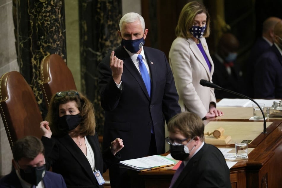 Ex-Vice President Mike Pence continues the count of electoral votes in the House Chamber during a reconvening of a joint session of Congress on January 7, 2021.