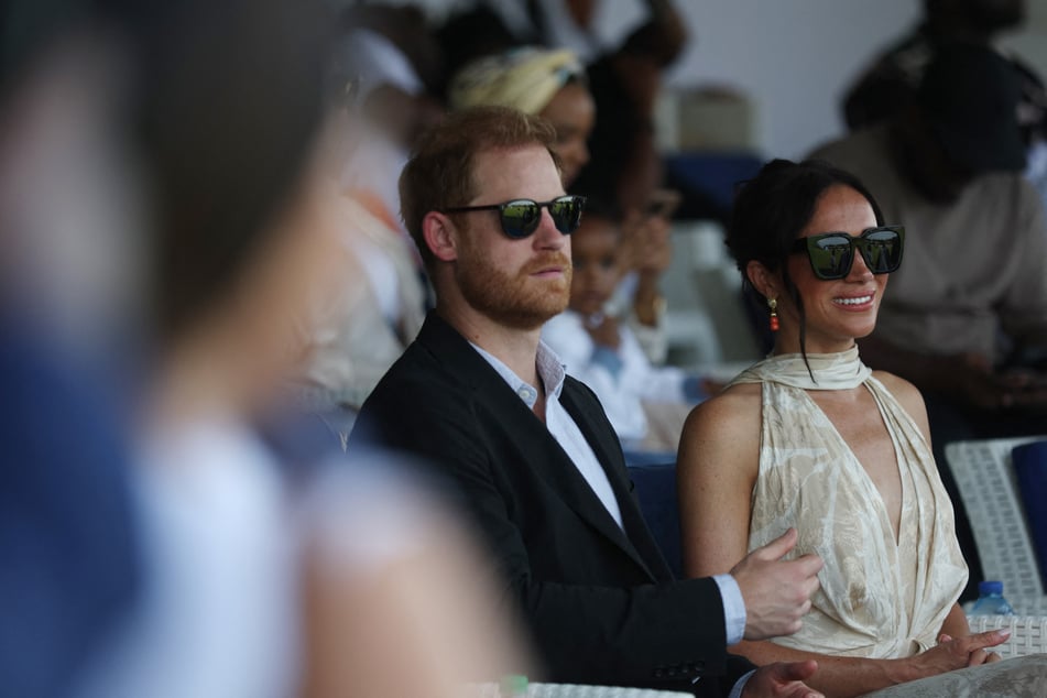 Prince Harry (l.) and Meghan Markle (r.) attend a charity polo game at the Ikoyi Polo Club in Lagos on Sunday as they visit Nigeria as part of celebrations of the Invictus Games' anniversary.