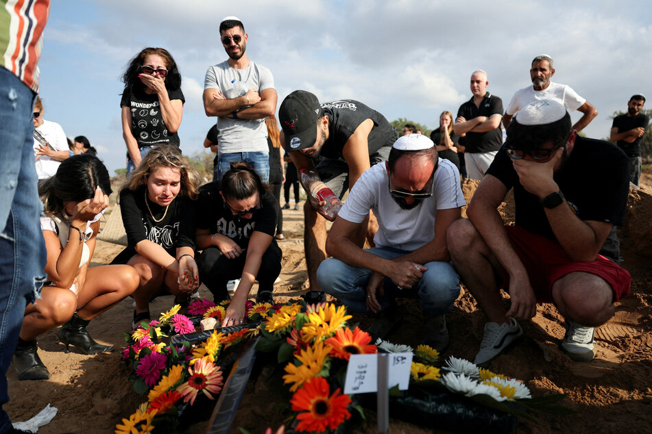 Mourners at the graveside of Eden Guez, who was killed in the Hamas attack on a music festival that left at least 260 people dead.