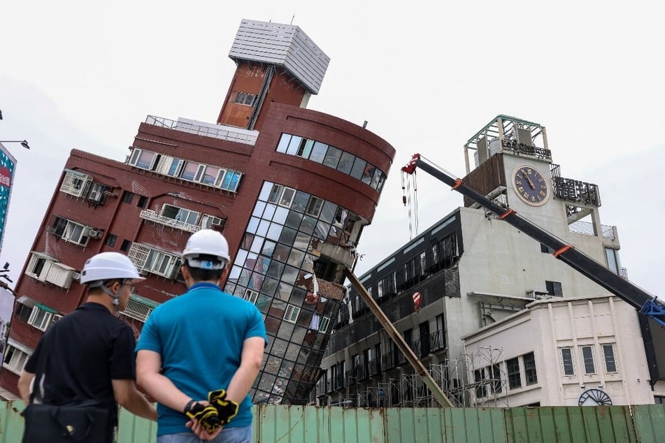 Heavy equipment is used to demolish the Uranus building, which was damaged in the April 3, 2024, earthquake in Hualien, Taiwan.