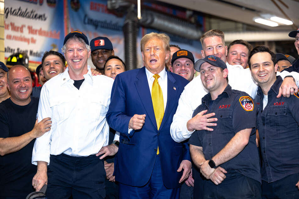 Donald Trump posing for photos with members of the FDNY Engine 2, Battalion 8 firehouse in New York City on May 02, 2024.