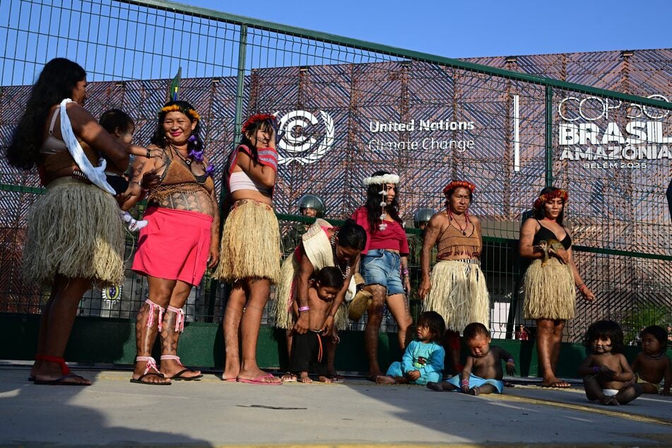 Members of the Indigenous Munduruku Ipereg Ayu movement wait outside the COP30 venue during a protest in Belem, Brazil on November 14, 2025.