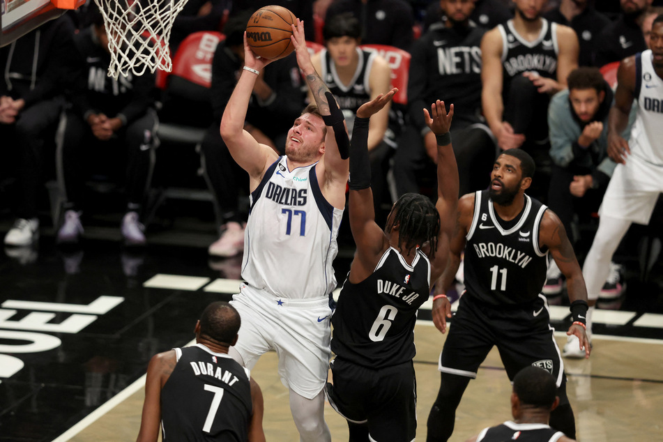 Luka Doncic drives to the basket against Brooklyn Nets forward David Duke Jr., forward Kevin Durant, and guard Kyrie Irving during the third quarter at Barclays Center.