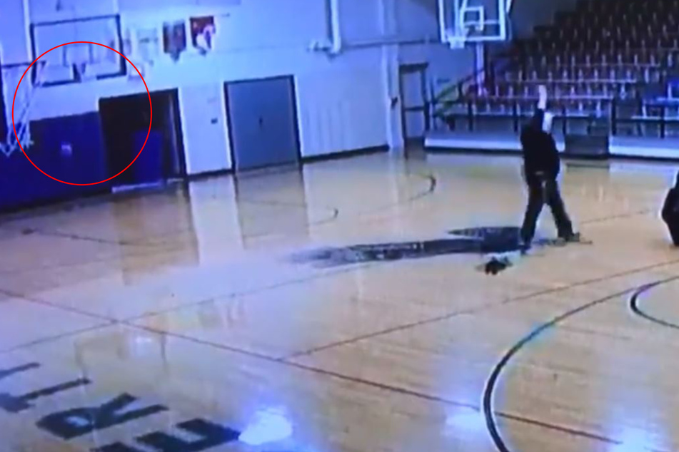 Backwards, the janitor threw the ball into the basket like it was the easiest thing in the world.