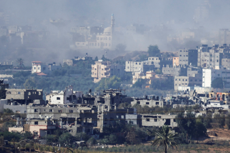 Smoke rises from damaged buildings in Gaza following Israeli airstrikes, as seen from southern Israel on November 4, 2023.