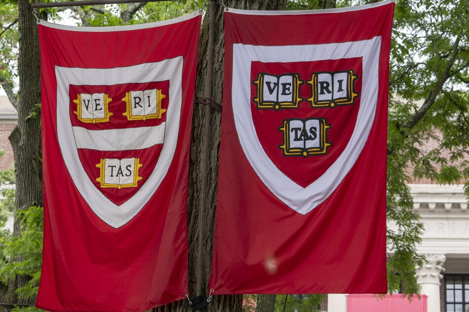 Harvard banners hang during the 374th Harvard Commencement in Harvard Yard in Cambridge, Massachusetts, on May 29, 2025.