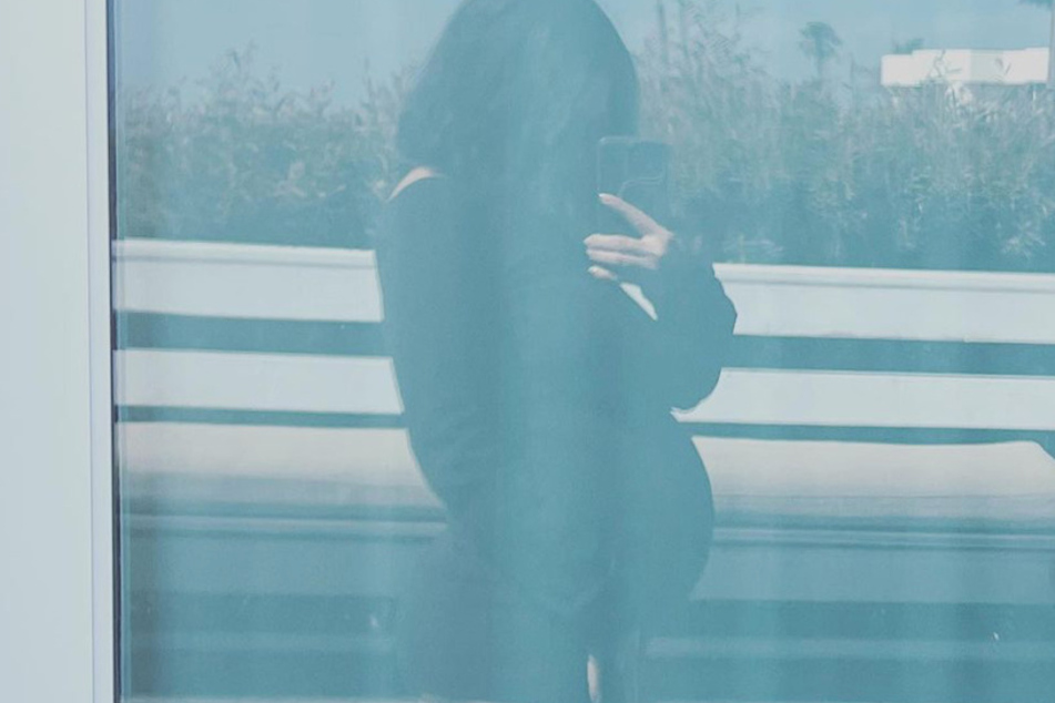 Kourtney Kardashian flashed her bump in a new pic from her recent beach vacation.