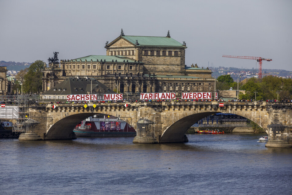 An der Augustusbrücke wurde ein Spruchband mit den Worten "Sachsen muss Tarifland werden!" befestigt.