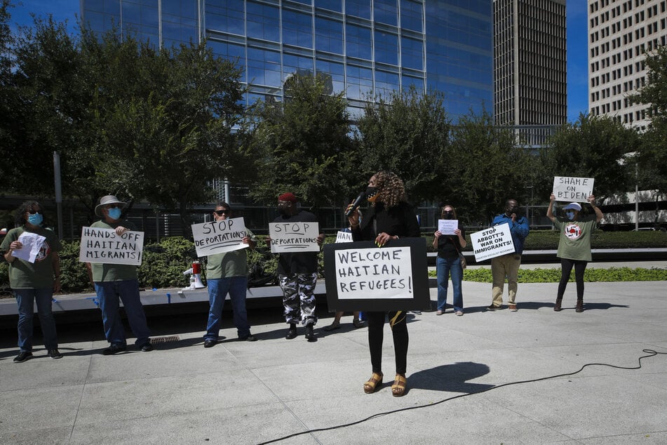 Protestors gather in front of the Leland Federal Building in Houston, Texas in opposition of the mass deportation of Haitian migrants.