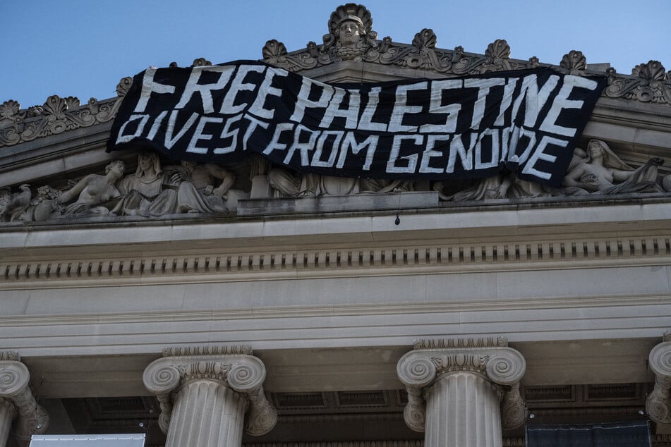 Pro-Palestinian demonstrators associated with the 'Within Our Lifetime' protest group, drop a banner at the Brooklyn Museum on May 31, 2024 in New York City.